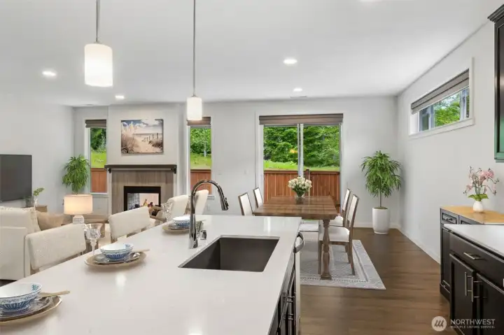 Every great party eventually ends up in the kitchen, and this island was clearly designed with that in mind. The expansive quartz surface provides plenty of room for meal prep, serving appetizers, spreading out holiday treats or simply gathering with friends while dinner is underway. An undermount sink keeps the clean lines uninterrupted, while the stainless steel dishwasher sits conveniently nearby for easy cleanup afterward, and unlike many kitchen islands that face a wall, this one enjoys beautiful views through the surrounding windows toward the protected wetlands beyond the backyard.