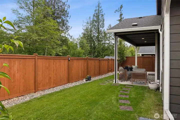 The custom 6-foot fence provides a beautiful backdrop while creating a secure and comfortable outdoor space, and the river rock borders add texture, definition and low-maintenance appeal around the lawn. If you have a green thumb, there is plenty of opportunity to add container gardens, colorful seasonal plantings or your own personal landscaping touches. Of course, you may find very little motivation to do much at all because the real landscaping masterpiece lies beyond the fence. Protected wetlands provide a stunning natural backdrop filled with lush greenery most of the year and beautiful seasonal color when autumn arrives, creating a view that changes with the seasons and never needs watering.