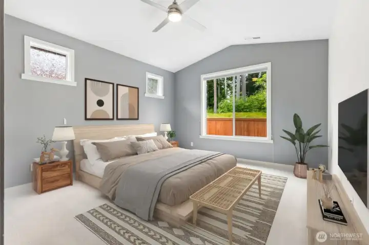 The primary suite is wonderfully spacious and benefits from the privacy of being tucked on the opposite side of the home from the guest bedrooms. Vaulted ceilings enhance the airy feel, while brand-new carpeting creates a fresh, move-in-ready foundation. A contemporary ceiling fan with integrated light adds comfort and style, and the thoughtfully placed clerestory-style windows high on the wall allow for greater flexibility when arranging furniture. The real showstopper, however, is the large picture window overlooking the protected wetlands behind the home, offering peaceful green views instead of neighboring rooftops.