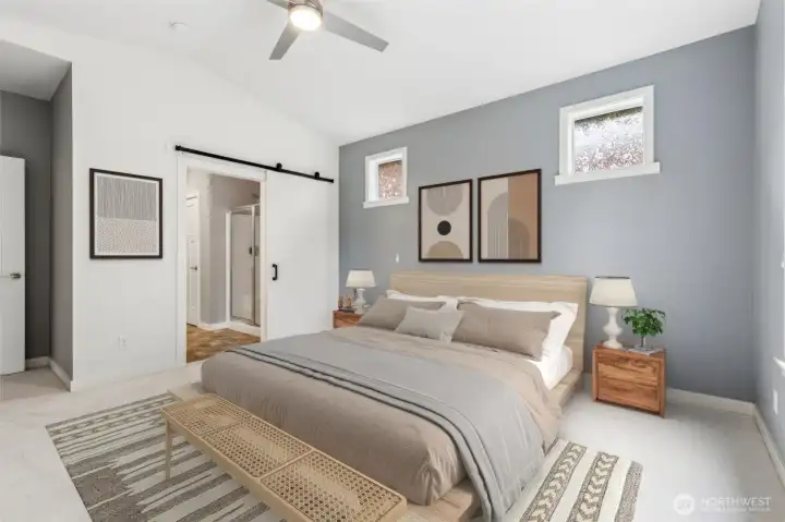 There is something wonderfully peaceful about this room. The soft powder-gray paint creates a serene backdrop that works beautifully with the home's warm cream walls, ivory trim and fresh carpeting, resulting in a color palette that feels timeless, relaxing and easy to personalize. The sliding barn door leading into the primary bath adds both style and function, while the vaulted ceiling enhances the spacious feel of the suite. Tucked away from the secondary bedrooms and overlooking protected green space, this room truly delivers the retreat-like atmosphere buyers are looking for. After a day spent enjoying Jubilee's incredible amenities, from the indoor pool and fitness center to the tennis courts, walking trails and social activities, you'll be glad to have such a peaceful place to recharge.