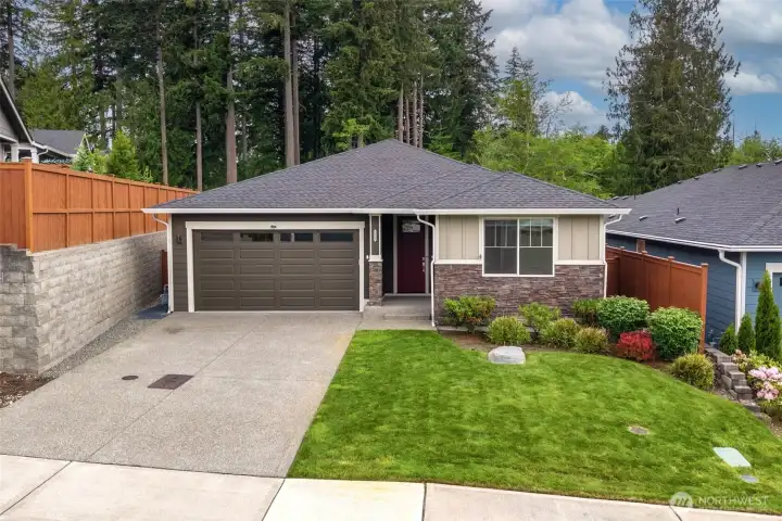 One of the underrated luxuries of this home is something you'll notice before you even step inside: a beautifully level driveway. Whether you're coming home with groceries, welcoming guests or simply navigating a frosty winter morning, having easy, flat access is one of those features that quietly improves everyday life. From the sidewalk in front of the home, an extensive network of community paths invites you to explore everything Jubilee has to offer. Miles of sidewalks and trails connect residents to athletic courts, community gathering spaces, recreation amenities and eventually down to the saltwater shoreline itself.