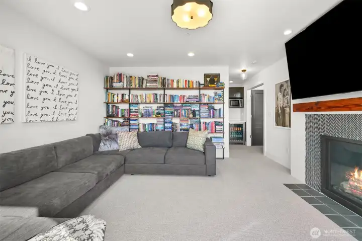 The media room upstairs is the perfect retreat for a movie night, or a quiet spot to read or play a game. Features a gas fireplace, wet bar and bathroom.