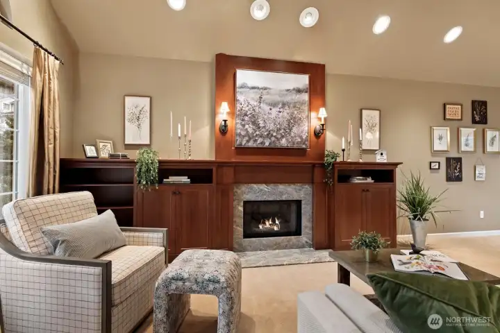 Custom-crafted cabinetry surrounds the gas fireplace, creating a warm and elevated focal point in the front living room.