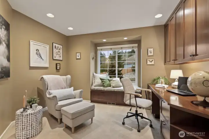 A main floor office just off the entry features French doors, a charming window seat.