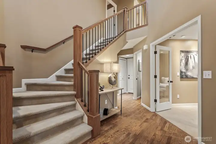 Rich hardwood floors and the custom built stair railings showcase the elegance of this front entrance.
