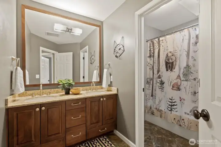 A remodeled guest bath with high end fixtures and tile work make this bathroom a joy to use.