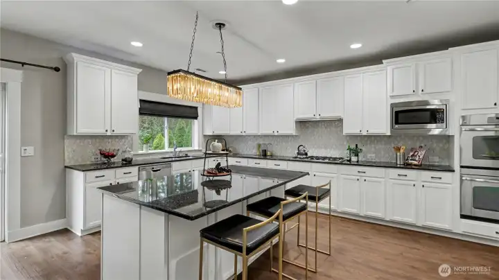 The spacious island offers the perfect place for meal prep, casual dining, or gathering with guests.