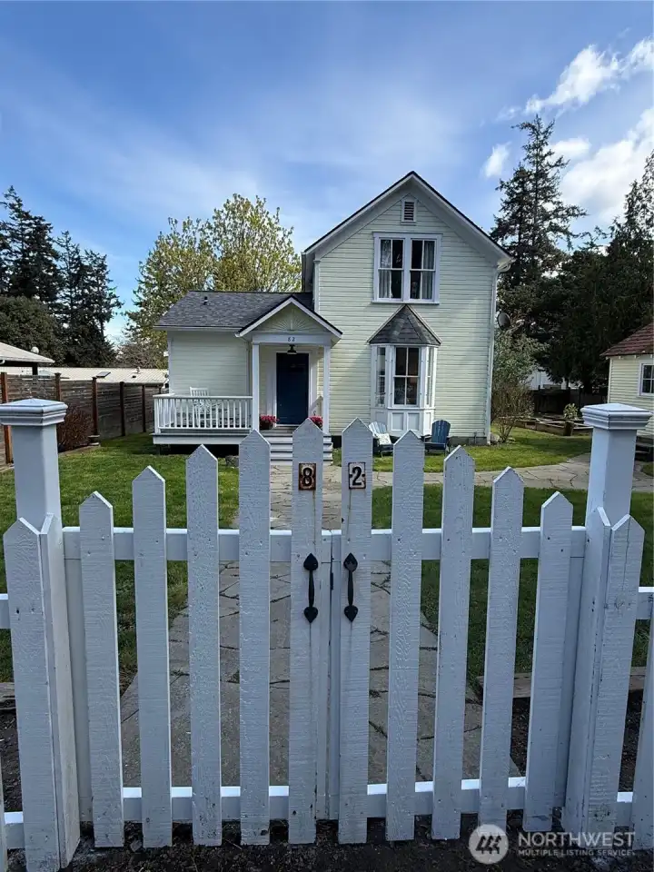 The white picket fence and gate welcome you into your fully fenced yard.