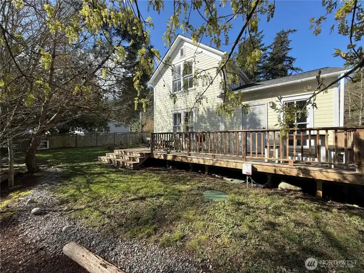 Expansive back deck has room for al fresco dining and enjoying views over the raised garden beds.