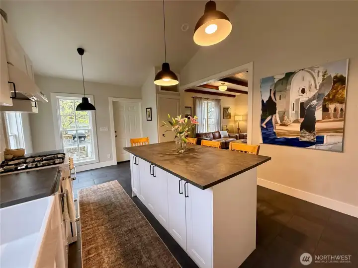 Kitchen island serves as both exceptional prep space as well as counter-top dining area.