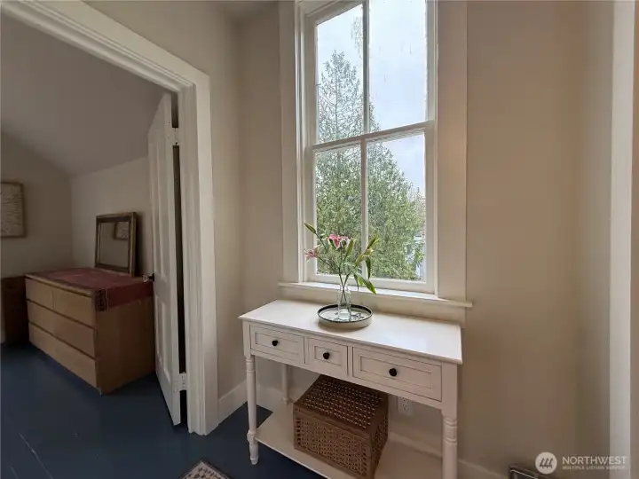 Landing at the top of the stairs between the primary and guest bedrooms.