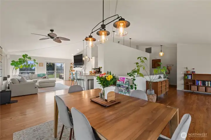 Looking room the dining room toward the family room on the left, the kitchen in the middle, and the sitting room on the right.