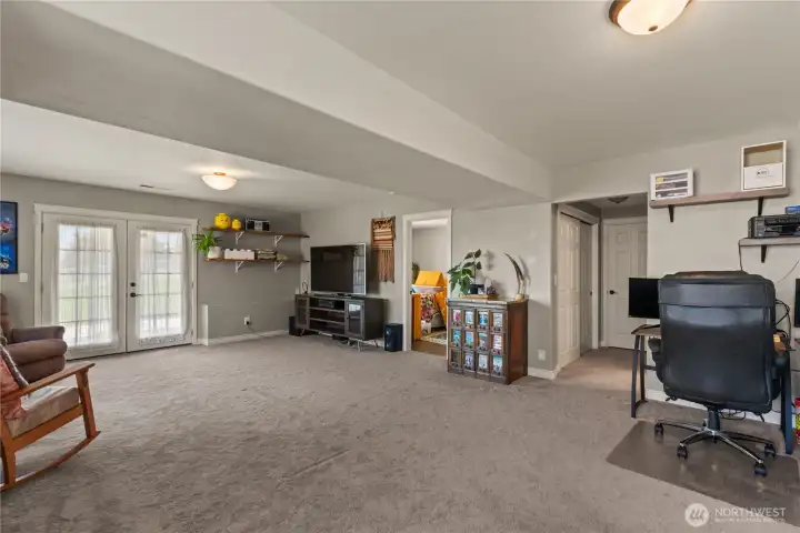 Downstairs family room with beautiful French doors that open to the covered patio