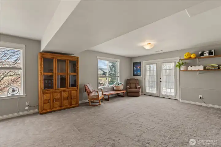 Downstairs family room with beautiful French doors that open to the covered patio