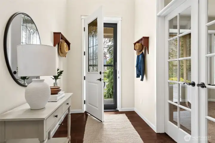 Grand entry with vaulted ceilings and gleaming engineered hardwood floors.