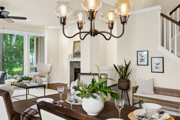 Dining room conveniently located off kitchen with views to golf course through living room. Designer light fixtures really make this home shine