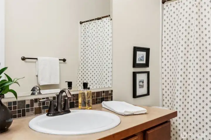 Main floor bathroom has full tub/shower combo