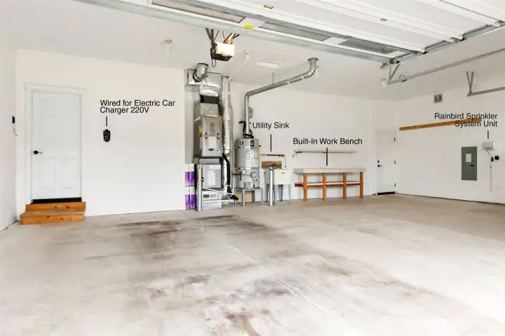 Spacious 3 car garage gives you room for storage, hobbies, and parking. Wired with 220V Electric Car Charger, practicle utility sink and large workbench.