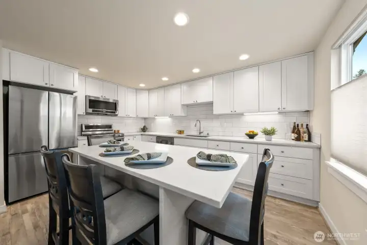 Kitchen with quartz counter top and ss appliances.