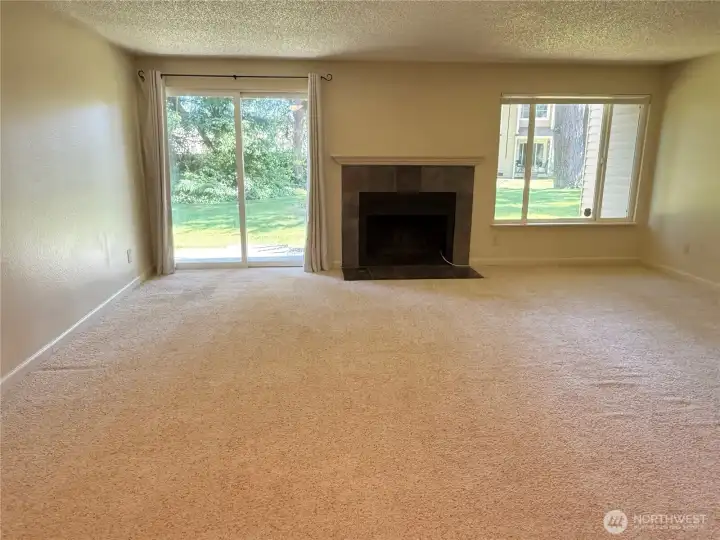 Spacious living room with wood burning fireplace