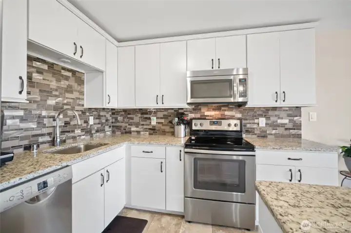 Stainless appliances, tiled backsplash and stylish counters.  Great cabinetry with good storage.