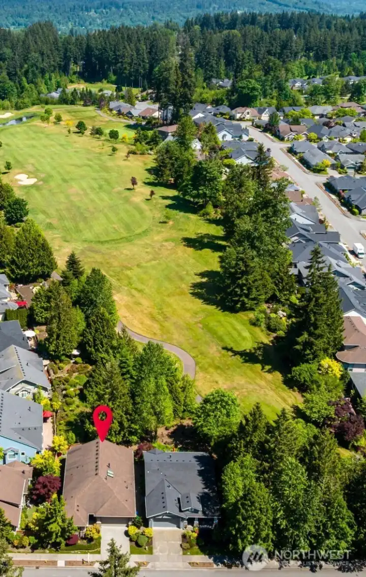 Beautiful Bainbridge model on the #6 tee box at The Golf Club at  Redmond Ridge.  Set back from the golf course...no fear of golf balls landing in your yard...just the peaceful serenity and privacy of the perfect location.    Notice that this beautiful home backs to the peaceful woods, not another home!  New Lifetime CertainTeed Landmark Shingle Roof coming August 3rd!