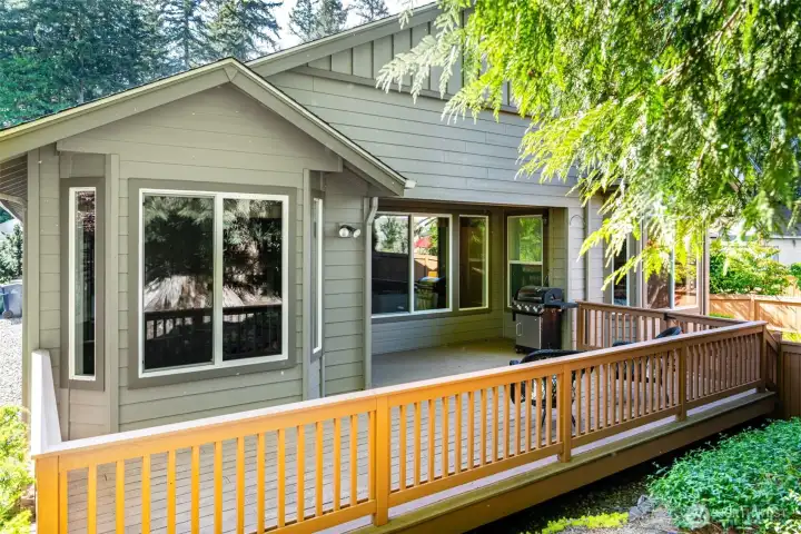 View of the back of the home and the deck.  The barbeque stays and is connected to the gas line...no need to haul propane tanks!