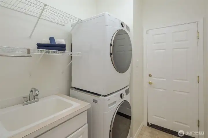 Utility/mud room off the garage with laundry sink.