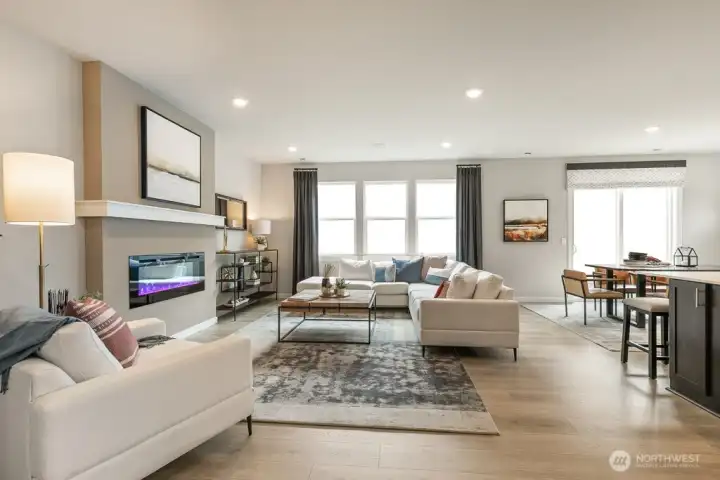 Large, sun drenched great room. Photo rendering is representational and may be virtually staged. Actual home is under construction and finishes, elevation, and paint colors may vary. See site agent for details.