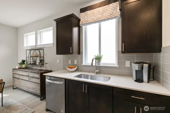 Window above your sink. Photo rendering is representational and may be virtually staged. Actual home is under construction and finishes, elevation, and paint colors may vary. See site agent for details.
