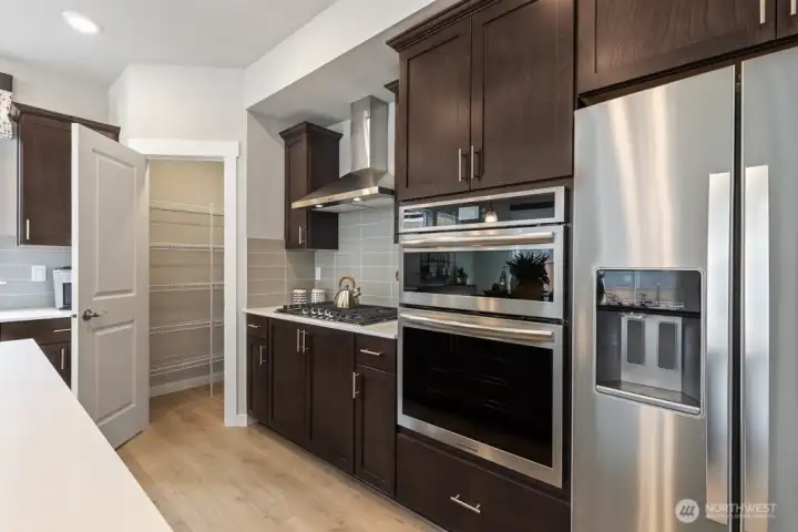 Stainless steel appliances. Photo rendering is representational and may be virtually staged. Actual home is under construction and finishes, elevation, and paint colors may vary. See site agent for details.