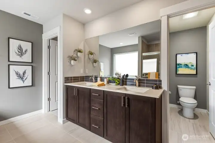 Double sink in primary bathroom. Photo rendering is representational and may be virtually staged. Actual home is under construction and finishes, elevation, and paint colors may vary. See site agent for details.