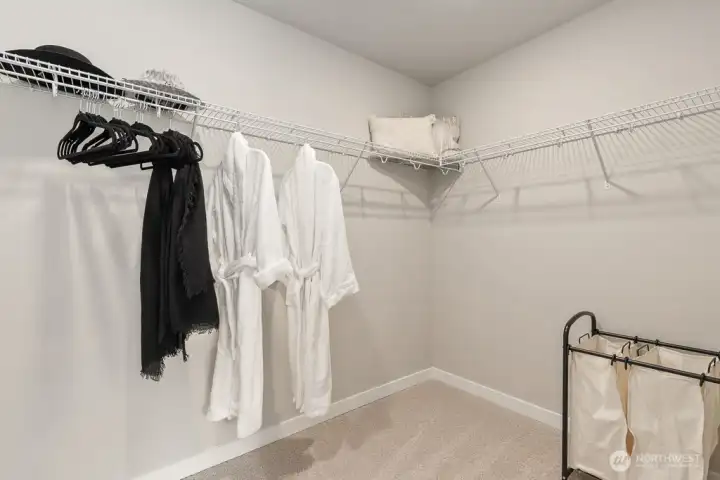 Walk in closet conveniently located near primary bathroom. Photo rendering is representational and may be virtually staged. Actual home is under construction and finishes, elevation, and paint colors may vary. See site agent for details.