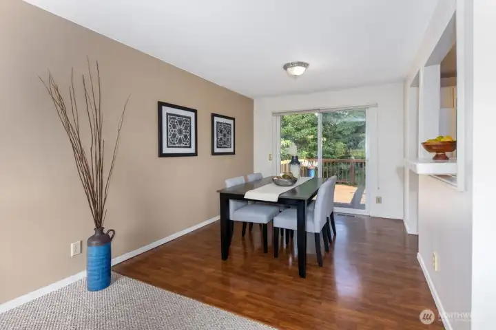 Beautiful Pergo floors and a layout that allows easy entertainment and dining to flow from the living room and kitchen into the dining room and outside onto the cedar deck.
