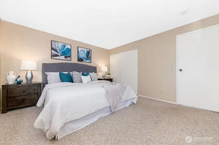 Large primary suite enjoys a view of the tranquil private backyard lined by mature statuesque trees and the convenience of a 3/4 bath ensuite.