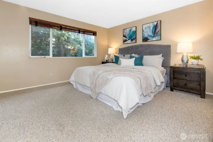 Large primary suite enjoys a view of the tranquil private backyard lined by mature statuesque trees and the convenience of a 3/4 bath ensuite.