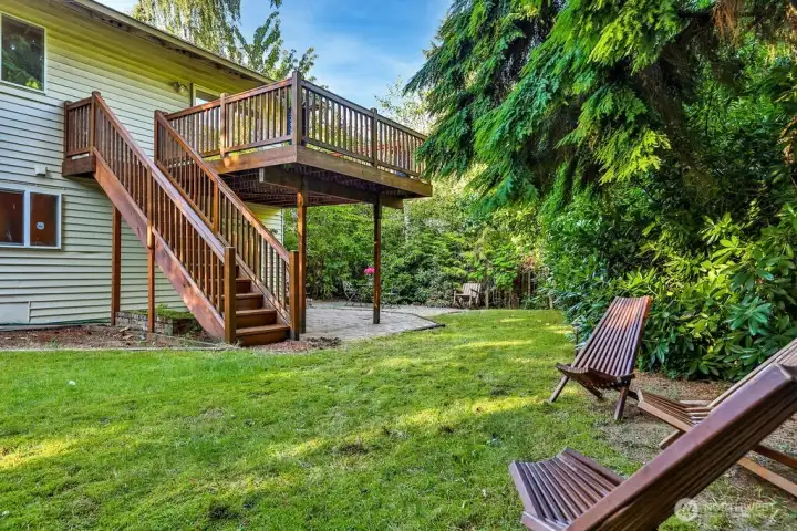 Newly stained Cedar deck overlooks the private backyard oasis creating 2 levels of entertainment in total privacy and flows effortlessly into the home.