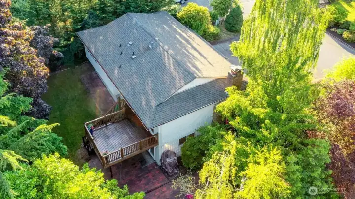 Surrounded by mature evergreen landscaping, cherry trees, and grape vines, the home's highlight is a beautiful, private backyard complete with a cedar deck, brick patio and line of statuesque trees providing total privacy.