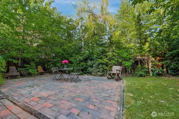 Surrounded by mature evergreen landscaping, cherry trees, and grape vines, the home's highlight is a beautiful, private backyard complete with a cedar deck, brick patio and line of statuesque trees providing total privacy.