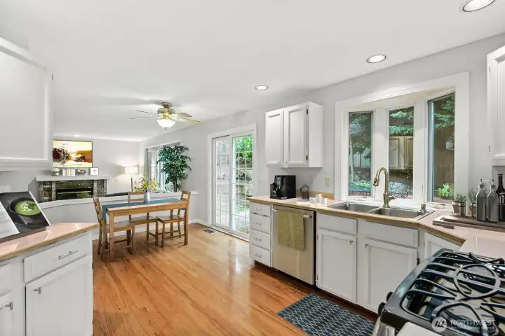 Spacious kitchen with lovely white cabinets and stainless appliances plus a casual dining area