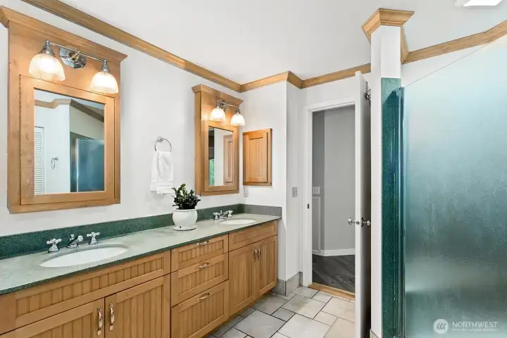 Primary bathroom with dual vanities and walk-in closet