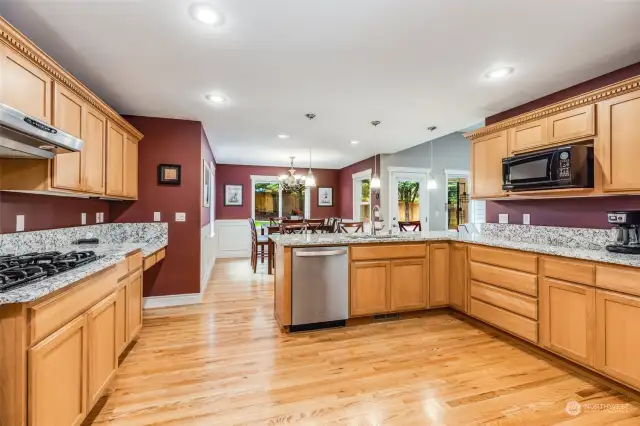 Large gas cooktop, oak floors and eat in kitchen