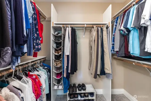 large walk in closet with shelving.