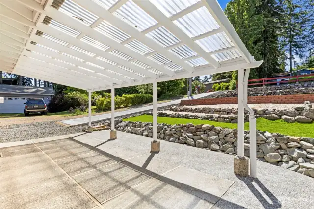 Deep carport/covered patio offers so many options for storage or entertaining.