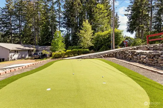 The front yard is terraced up to the street for maximum usage AND to accommodate the putting green!