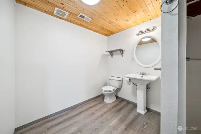 Lower level 3/4 bathroom. LVP flooring & tongue & groove ceiling.