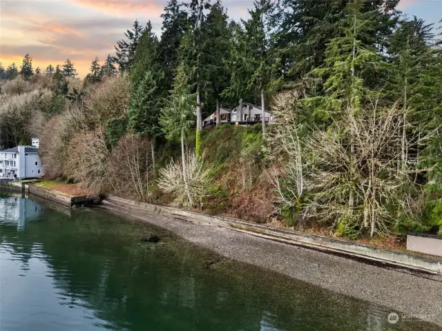 Almost 300 feet of CONCRETE BULKHEAD you cannot replicate. Easy switchback path to the beach to the right AND easement to use boat launch immediately to the North. It is adjacent to the property. EASY BEACH ACCESS.