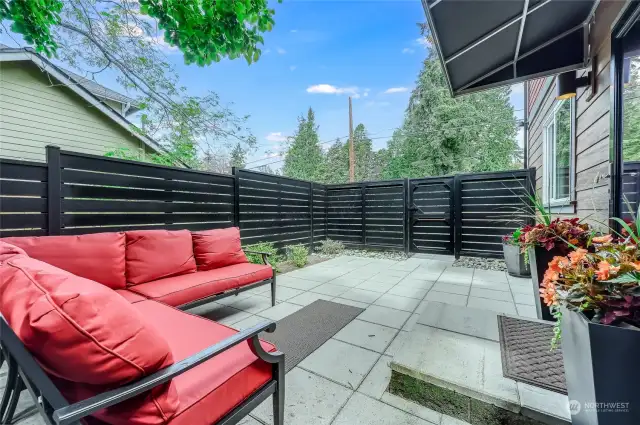 Fully fenced yard, spacious patio area, and garden space.