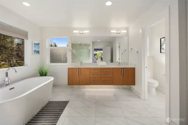 Primary bathroom with heated floors and underlit cabinets.