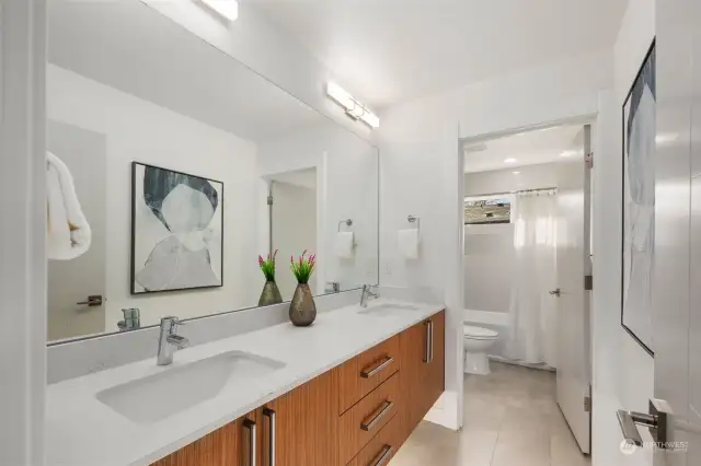 Full bathroom with dual sinks upstairs.